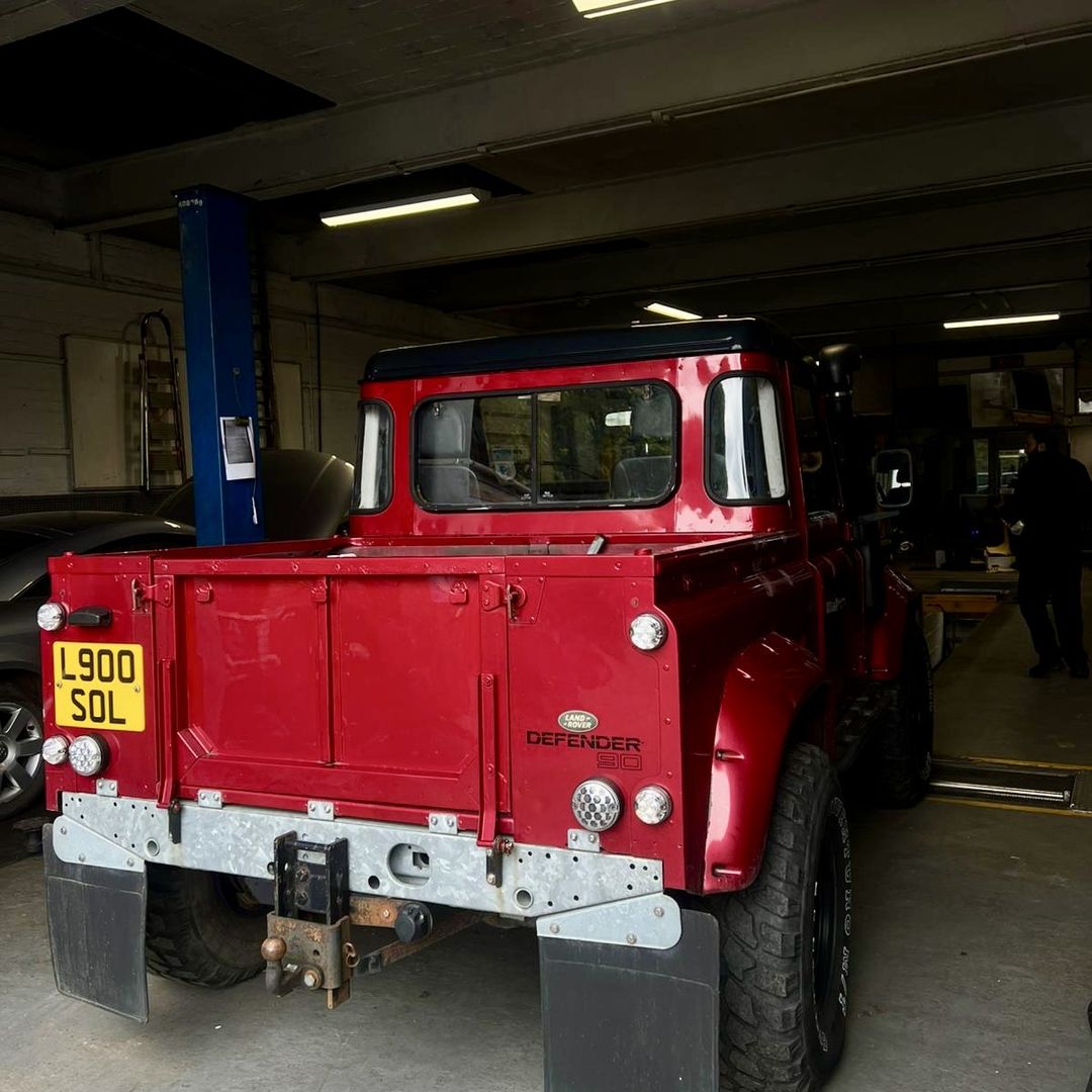 Land Rover Defender up on the ramp at 5 Star Motors